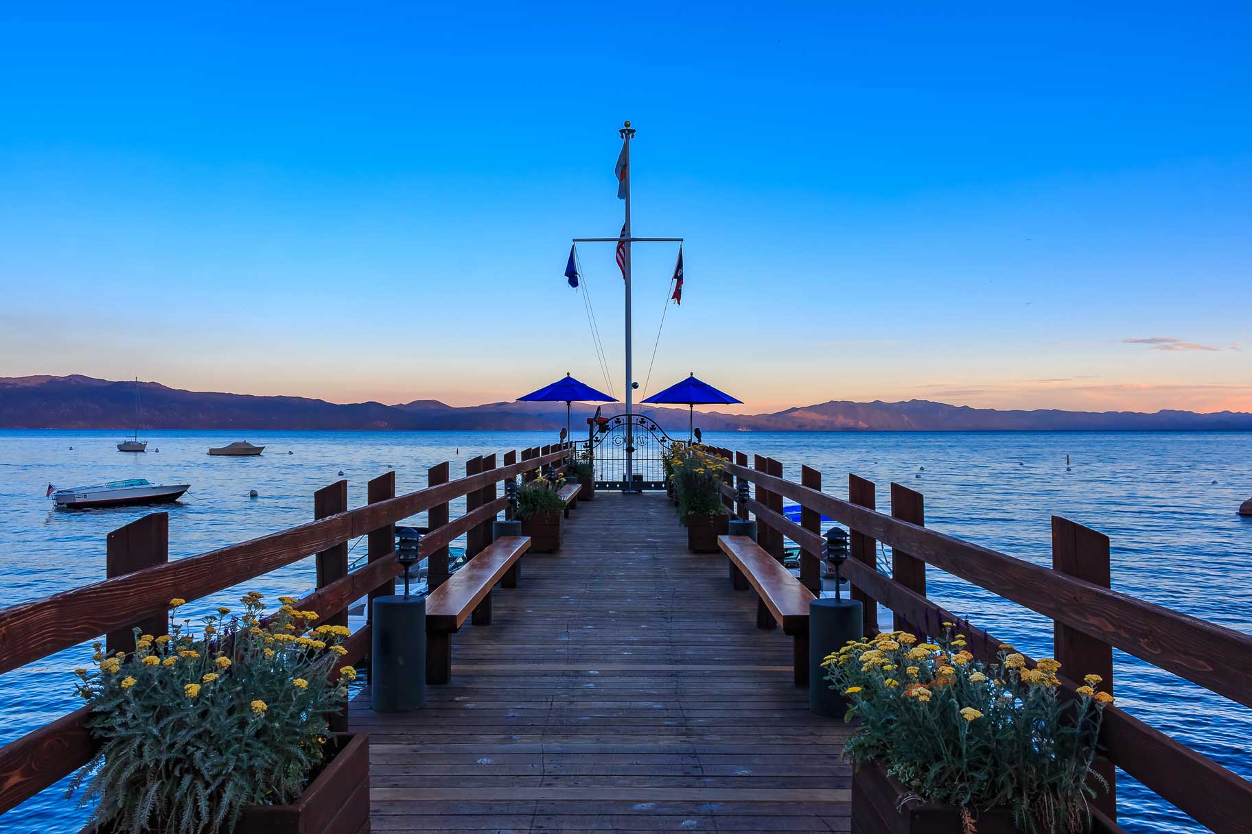 Dock on Lake Tahoe at sunset with flower pots